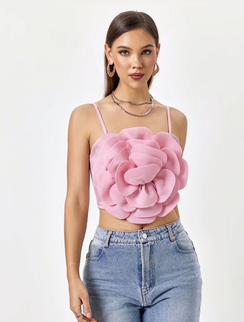 Woman wearing a pink floral top and blue jeans on a white background