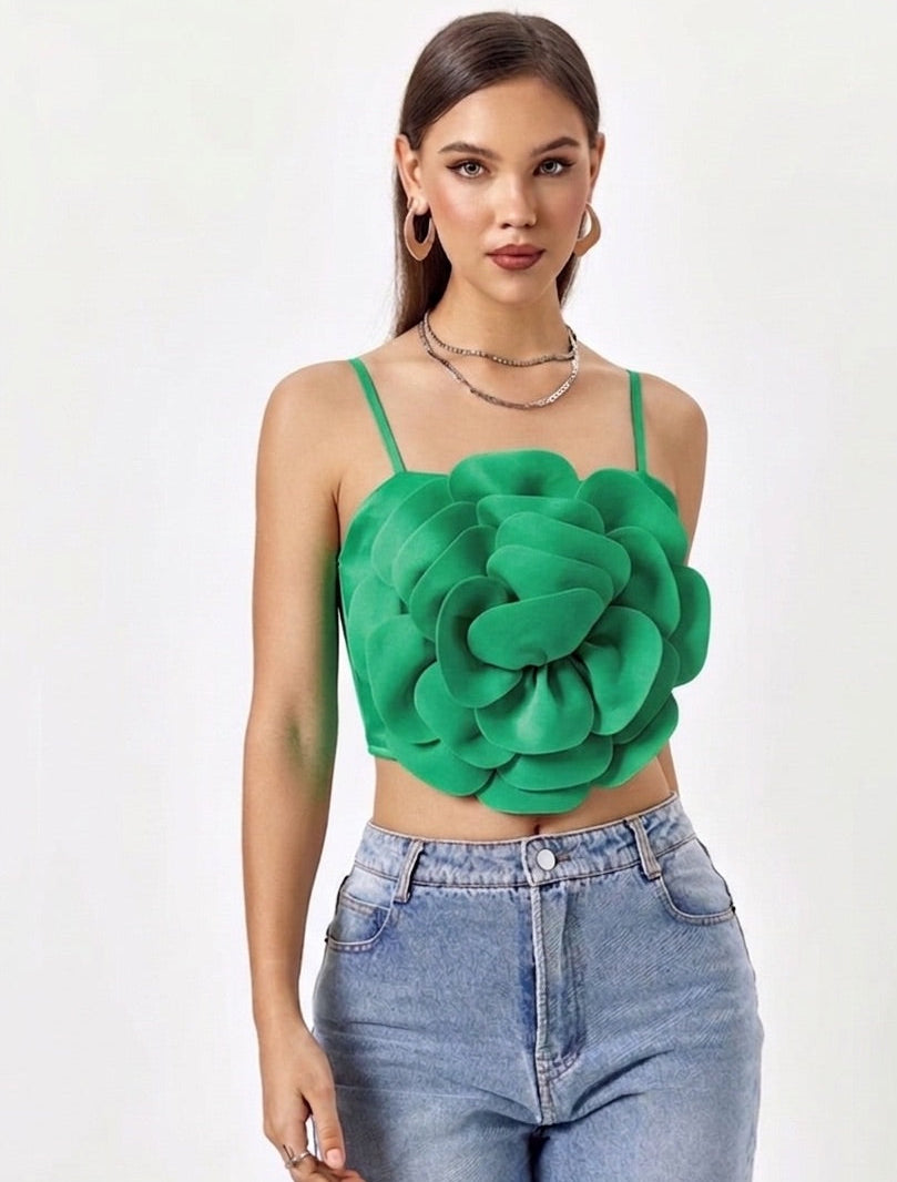 Woman wearing a green floral top and blue jeans on a white background