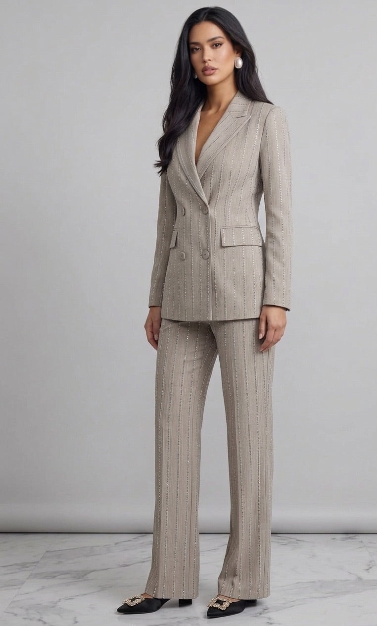 Woman wearing a beige pinstripe suit against a plain background