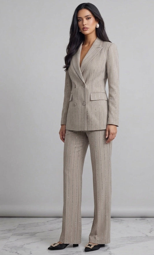 Woman wearing a beige pinstripe suit against a plain background