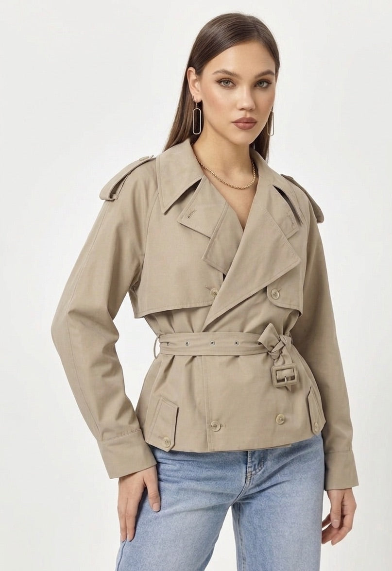 Woman wearing a beige trench coat on a white background
