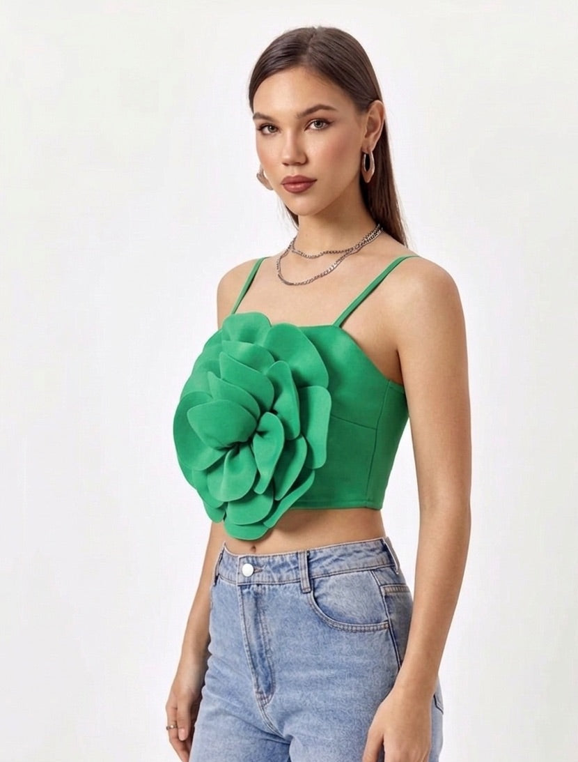 Woman wearing a green floral top and blue jeans on a white background